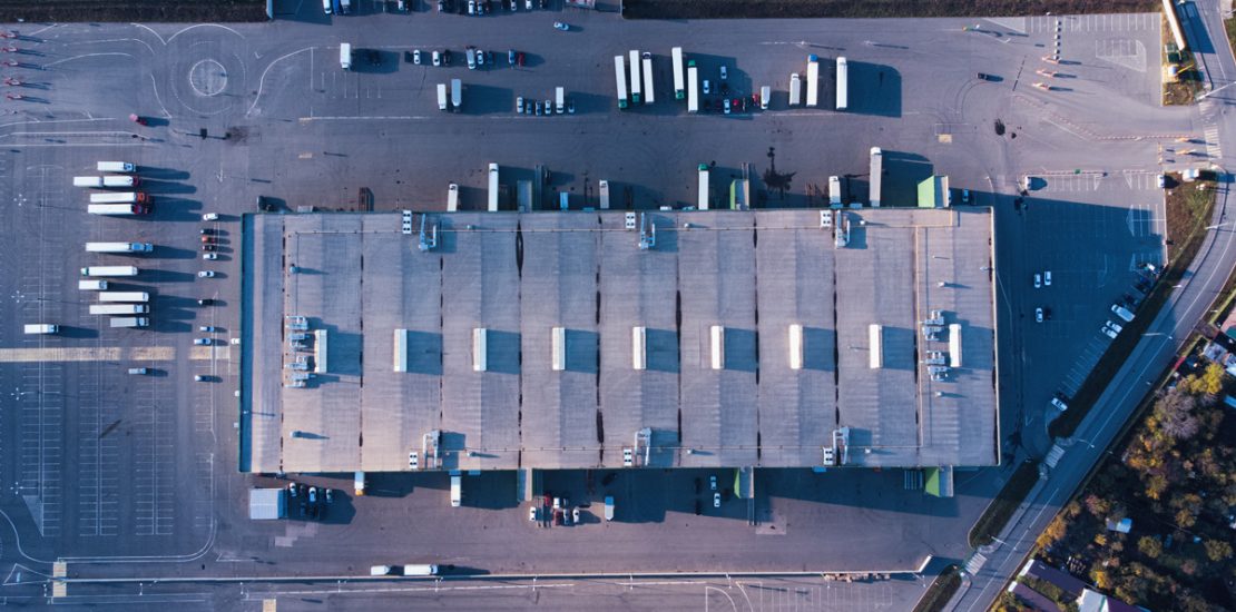 vecteezy_aerial-top-down-view-of-dock-warehouse-and-trucks-with_13953558