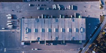 vecteezy_aerial-top-down-view-of-dock-warehouse-and-trucks-with_13953558